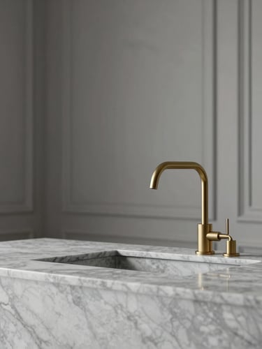 Close-up of premium interior finishes, marble counter, minimalist brass faucet, soft natural side light, architectural detail