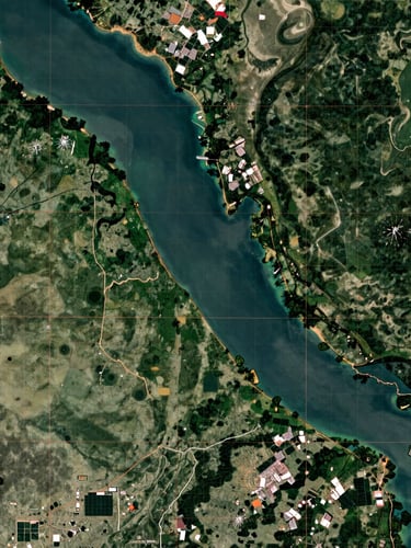 Wide panoramic satellite cartography overlay of the Amapá coast and Amazon river mouth, displaying technical green and copper vector gridlines, sharp contrast, natural daylight.