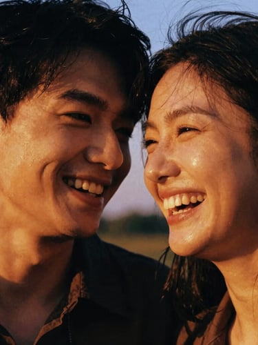Candid close-up of a laughing couple at golden hour, warm ambient light, rich saturated tones, 35mm film grain, cinematic framing