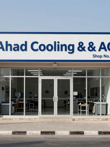 Wide environmental shot of Ahmad Cooling & AC storefront, labeled Shop No. 44 on Haffr Al Baten Street in Dammam, intense bright daylight, clean industrial workshop signage.