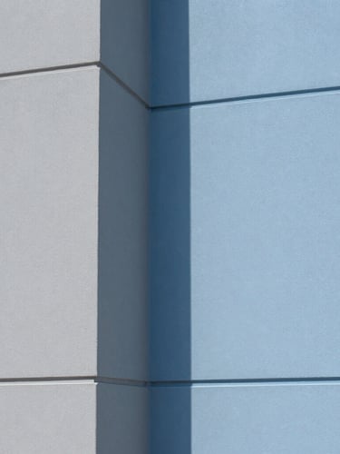 Close-up portrait of a perfectly masked interior corner, crisp architectural photography, bright natural daylight, clean blue and gray tones, sharp focus, 35mm