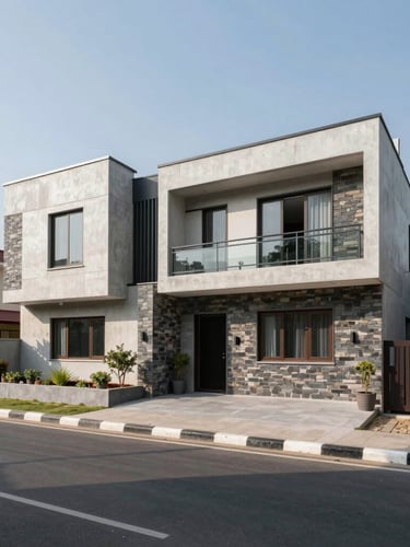 Wide-angle architectural photograph of a modern residential house in Lalitpur, featuring clean concrete lines, local stone accents, bright natural daylight, and a wide blacktopped road in the foreground.