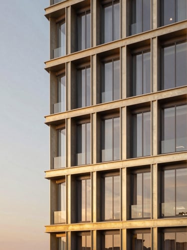 Wide panoramic architectural rendering of a modern luxury building facade in São Paulo at sunset, showcasing champagne-gold metallic structural frames, dark concrete textures, and large glass windows reflecting warm twilight sky, with copy space on the left.