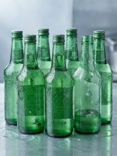 Crisp commercial product photography of condensation-beaded green Chamisul bottles, cool emerald and silver tones, sharp focus, bright studio lighting.