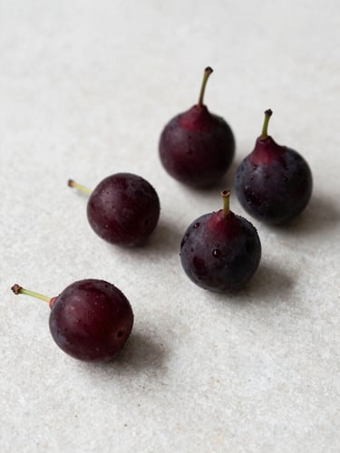 Minimalist Scandinavian food photography, raw organic ingredients on a clean light stone tabletop, soft natural side-light, high-contrast deep crimson tones, 35mm lens