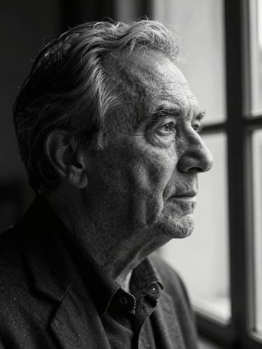 Candid black-and-white portrait of a founder in deep focus, looking thoughtfully out a window, moody natural light, deep shadows