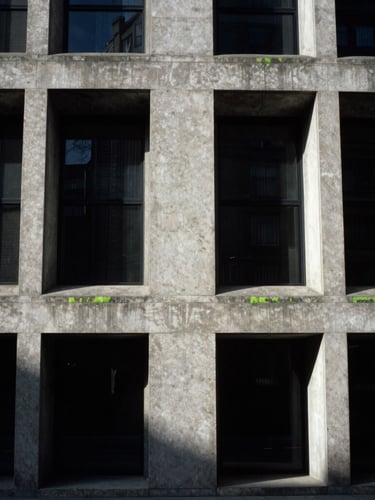 Stark brutalist concrete architecture in London, sharp late-afternoon shadows, high contrast, minimalist editorial composition, 35mm photography