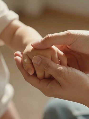 Close-up of a mother gently holding her child's hand, warm morning sunlight, natural textures, soft focus, intimate and emotional atmosphere