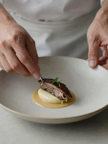 Close-up of chef hands carefully plating a minimalist dish, soft scandinavian daylight, matte finish, muted earth tones, 35mm lens