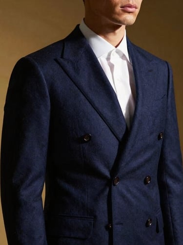 Studio fashion portrait of a man in a sharp navy blue double-breasted suit, crisp white shirt, dramatic side lighting highlighting the fine wool texture, high-contrast luxury editorial style.