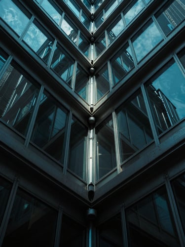 Dramatic low-angle portrait of a steel-and-glass architectural joint, cool cyan ambient light cutting through deep shadows, ultra-sharp details.