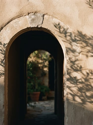 Architectural close-up of a warm stucco archway in soft Mediterranean sunlight, casting long elegant shadows, minimalist aesthetic, 35mm photography