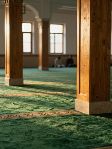 Warm interior of a mosque during a peaceful evening gathering, soft light illuminating wooden pillars and green carpets, editorial photography