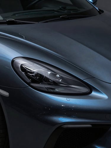 Dramatic low-key automotive photography, sharp linear metallic blue highlights tracing the contour of a pristine dark luxury sports car, ultra-sharp macro detail of paint reflection, 35mm