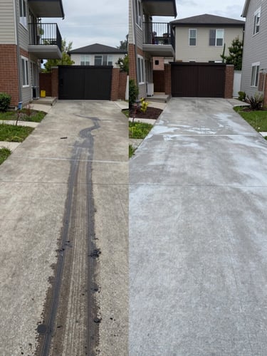 Split before-and-after frame of a concrete driveway near a Brossard condo building — left half shows dark oil stains and rubber marks, right half shows the same surface freshly pressure-washed to clean pale grey, photographed under flat overcast daylight for accurate color contrast