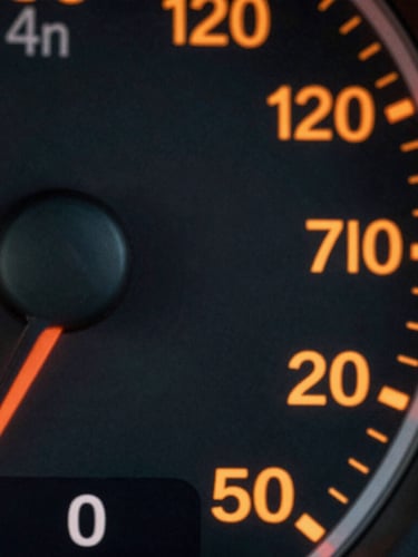 Macro close-up of high-contrast dashboard metrics on a dark screen, sharp safety-orange data lines and clean monospaced typography, shallow depth of field.