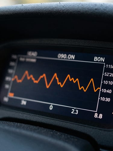 Macro shot of a dark dashboard screen showing real-time lead conversion metrics and sharp safety-orange data lines under direct morning sunlight.