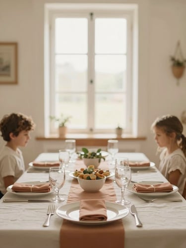 Warmly lit interior of El Encanto, set up for a family celebration, with soft focus on a table setting, natural window light, cream and terracotta tones, shallow depth of field, 35mm.
