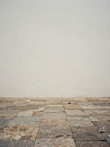 Minimalist fine art photography of a quiet stone courtyard in Brazil, soft diffused overcast light, desaturated earth tones, quiet contemplative composition, 35mm film