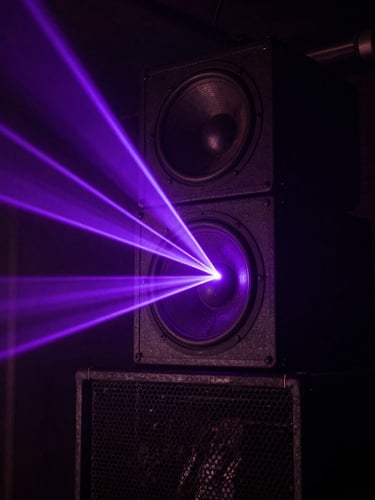 Close-up of a custom-tuned subwoofer stack in a dark subterranean club, sharp electric violet laser beams slicing across the metal grille, heavy haze, high contrast, deep shadows, 35mm