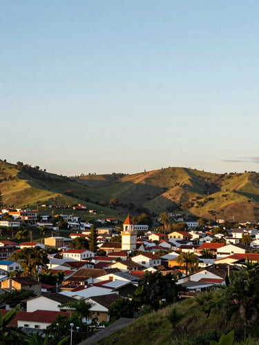 Wide panoramic sunset view of Portovelo, Ecuador, nestled in the green hills of El Oro, soft golden light, clean composition, 35mm
