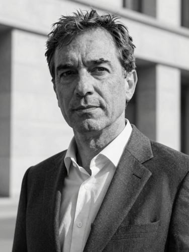 B&W medium-close portrait of Andrea Santoni, an Italian executive in his late 40s, sharp suit, thoughtful expression, clean architectural background, high contrast daylight.