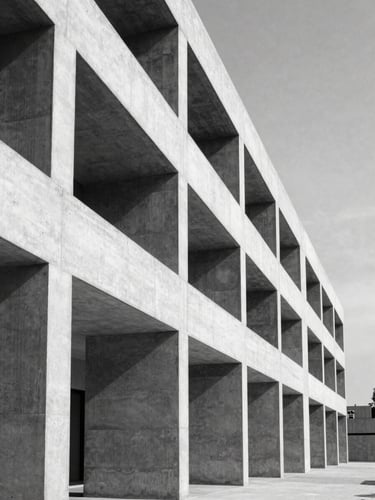 Crisp black-and-white architectural photography of a modern concrete structure with clean, repeating geometric lines, high-contrast natural daylight, emphasizing perspective and order.