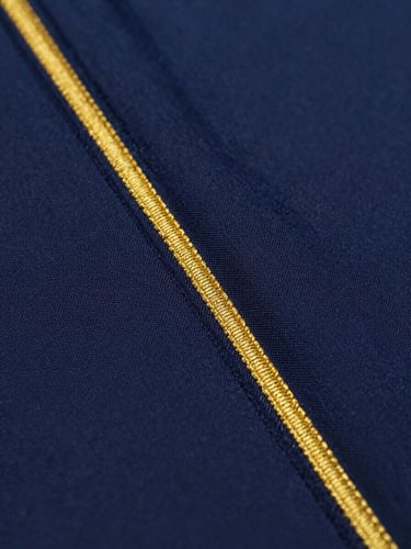Macro shot of premium deep navy fabric with precise gold stitching, high-contrast studio lighting, crisp texture focus