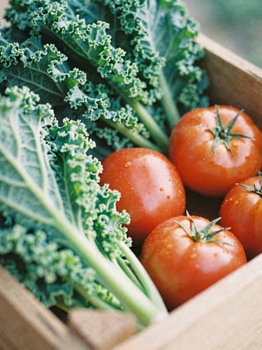 Close-up of fresh-picked local produce, including crisp green kale and bright red heirloom tomatoes, in a rustic wooden crate under soft morning daylight, 35mm film look.