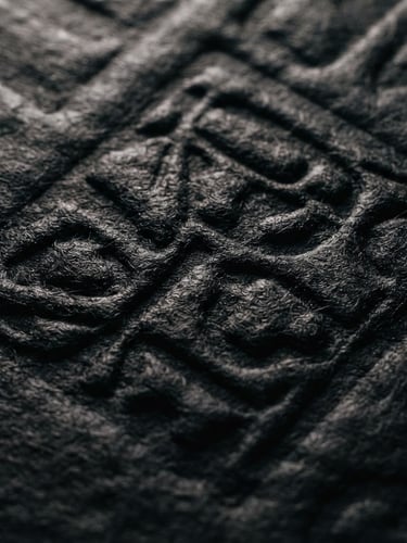 Macro crop of heavy textured paper with deep letterpress impression, dramatic chiaroscuro studio lighting, dark ink-black tones, 35mm film grain