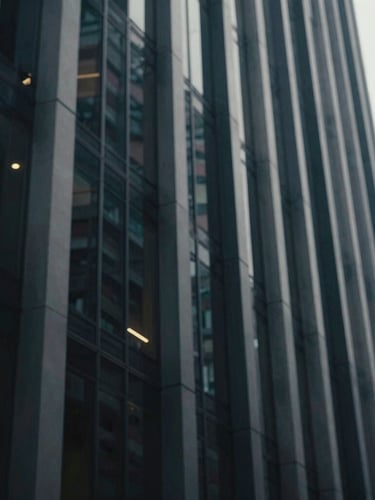 Perspective view of a modern steel and glass skyscraper facade in Mexico City, cool daylight, shallow depth of field, 35mm