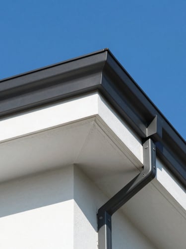 Close-up of newly installed white PVC under-cladding and dark grey aluminum fascia boards on a modern house roofline, crisp details, bright daylight