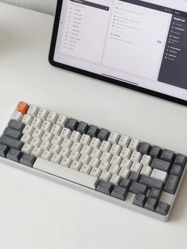 Overhead flat-lay of a minimalist workspace with a mechanical keyboard, a clean off-white desk, and a crisp high-contrast UI mockup on an iPad screen, soft natural daylight, 35mm
