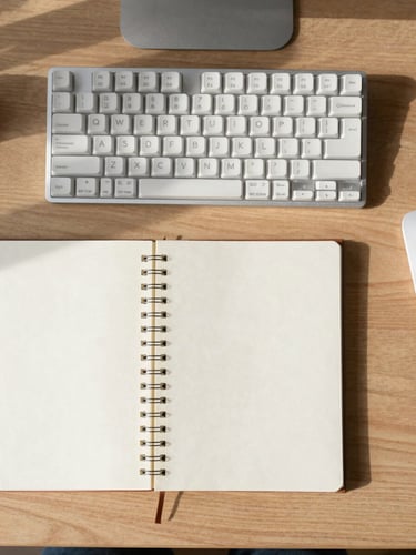 Overhead flat-lay of a minimalist wooden desk with a mechanical keyboard, a clean notebook, and soft natural daylight casting gentle shadows, 35mm.
