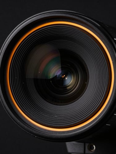 Tight macro shot of a sleek matte black security camera lens with a sharp amber rim light, high-contrast technical studio photography