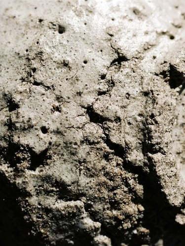 Macro close-up of textured ceramic glaze under harsh direct sunlight, deep shadows, neutral tones, 35mm lens