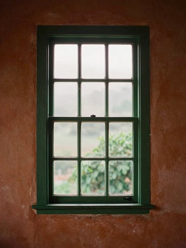 Warm editorial travel photography of a colonial window in Bananeiras, soft misty morning light, terracotta and forest green tones, 35mm film aesthetic