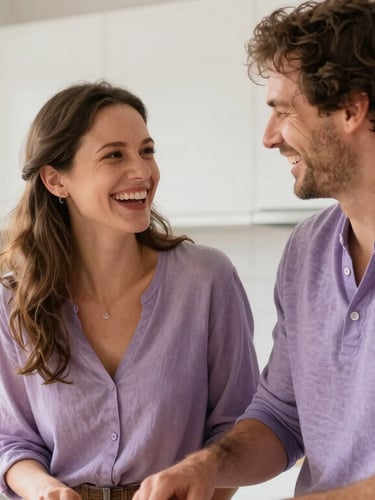 A happy Caucasian couple laughing together while cooking in their bright, sunlit kitchen, warm natural light, candid lifestyle photography