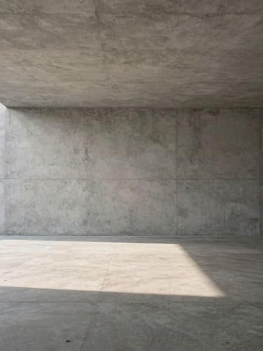 Wide architectural perspective of a minimalist concrete interior, soft diffused morning light casting long subtle shadows, elegant negative space on the left