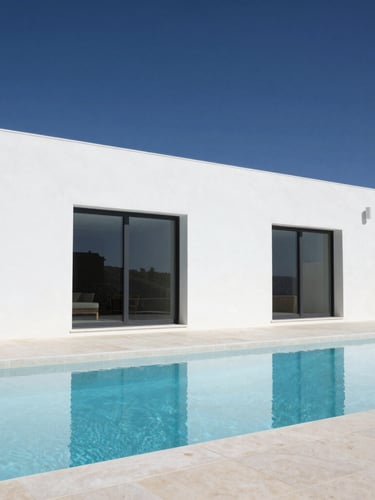 High-end architectural detail of a modern minimalist Algarve villa terrace with clean white concrete lines, pristine swimming pool reflecting deep blue sky, bright natural daylight, sharp shadows, 35mm photography