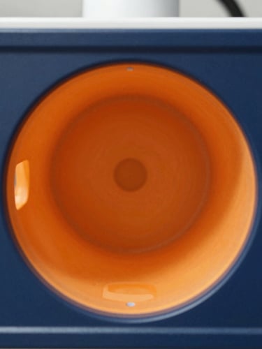 Macro shot of a high-tech diagnostic screen displaying a perfectly clean and clear pipe interior, bright daylight, high-contrast navy and orange tones