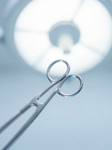 Sharp macro shot of sterile surgical blades in high-key clinical studio lighting, cool blue and white tones, absolute precision.