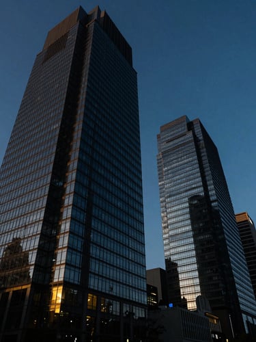 Low-angle dramatic architectural shot of modern glass skyscrapers in Paseo de la Reforma, Mexico City, deep blue hour lighting, sharp contrast
