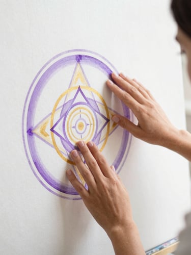 Elena Vega in her studio, bathed in natural light, contemplative, hands gently touching a canvas with violet and gold sacred geometry, high-key white backdrop, soft focus, 50mm