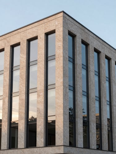 Wide architectural angle of a modern commercial building facade, warm travertine stone, clean glass reflections, soft evening light