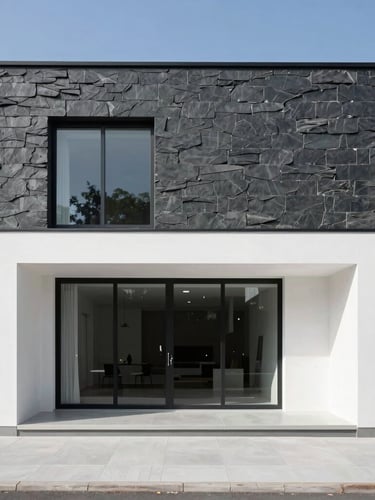 Straight-on architectural elevation of a modern minimalist house facade, bright natural daylight, sharp clean shadows, high-contrast slate and white tones