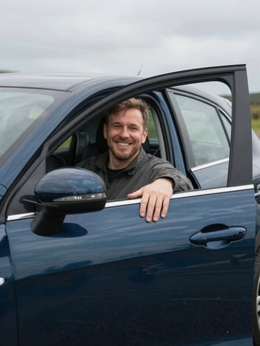 A friendly local driver in a clean dark blue car opening the passenger door with a welcoming smile, soft overcast Welsh daylight, honest editorial style.