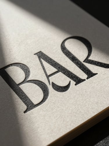 High-contrast portrait studio shot of physical brand collateral, thick textured paper with deep embossed typography, sharp directional side shadows, modern minimalist aesthetic.