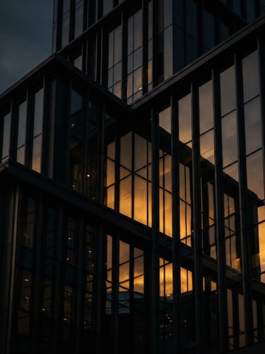 Sleek architectural close-up of a modern steel and glass skyscraper, dramatic low-key lighting, sharp directional key lights, golden hour reflections on dark metal, 35mm