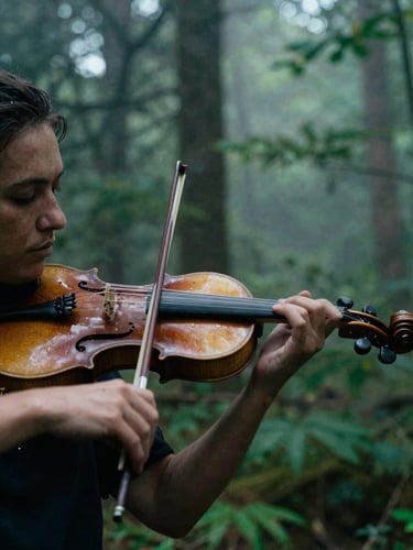 Extreme portrait close-up of a rustic wooden violin being played in a misty forest, moody cinematic film photography, natural overcast daylight, deep forest greens, 35mm anamorphic lens